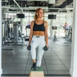 Woman working out in the gym with weights