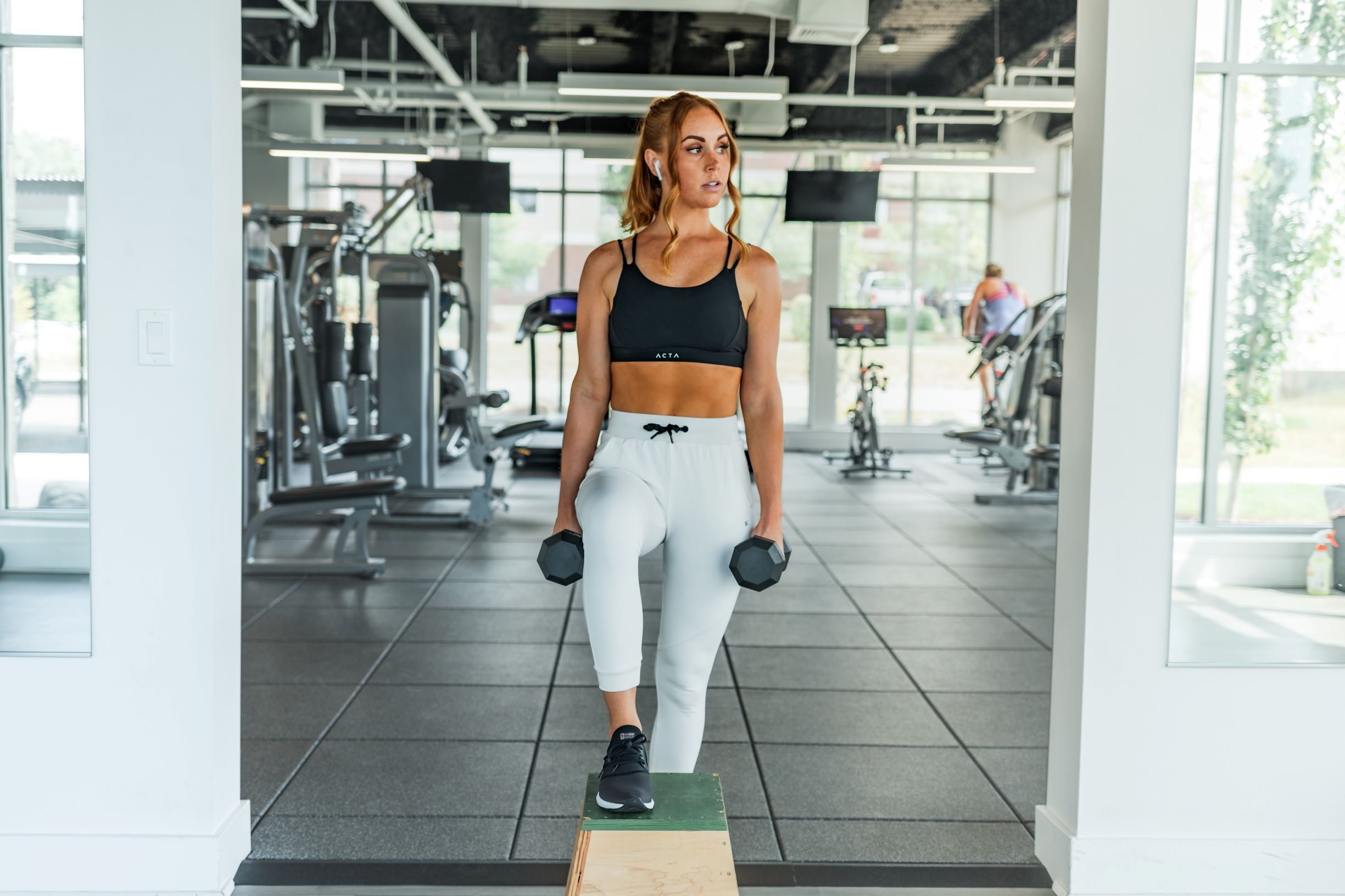 Woman working out in the gym with weights