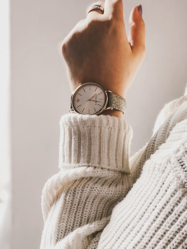 woman wearing a watch with white sweater on not wasting time