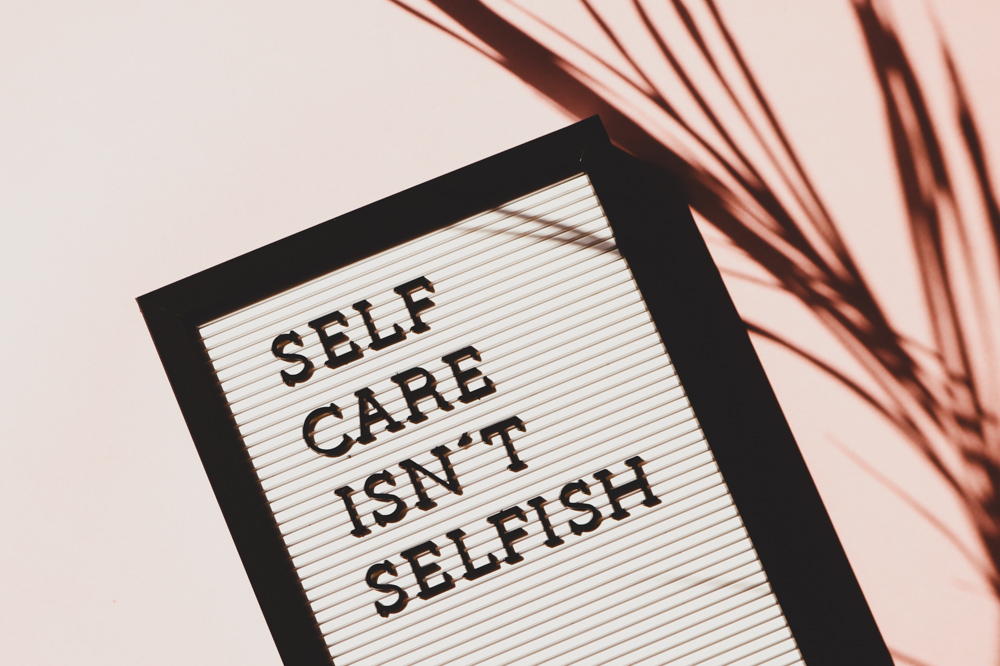 self care isn't selfish sign with pink background for 10 life tips