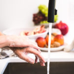 woman washing hands preventing coronavirus