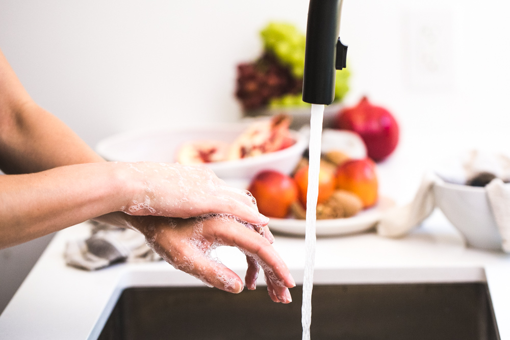 woman washing hands preventing coronavirus